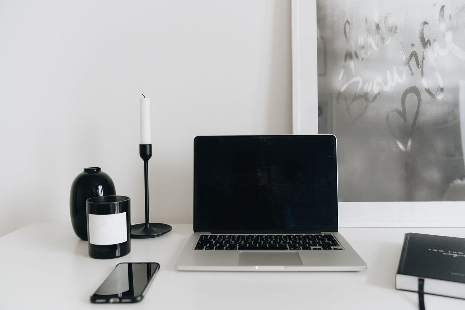A laptop and mobile phone on a home workspace table