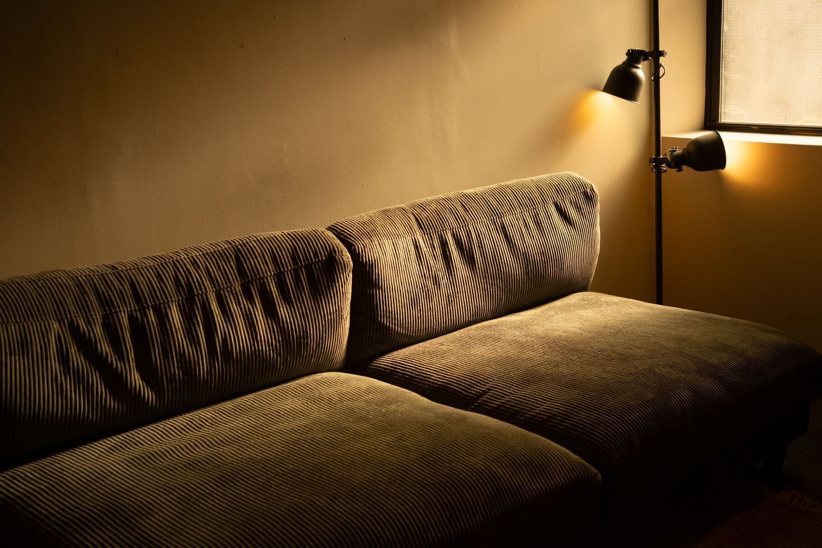 A sofa and warm lighting in a household living area