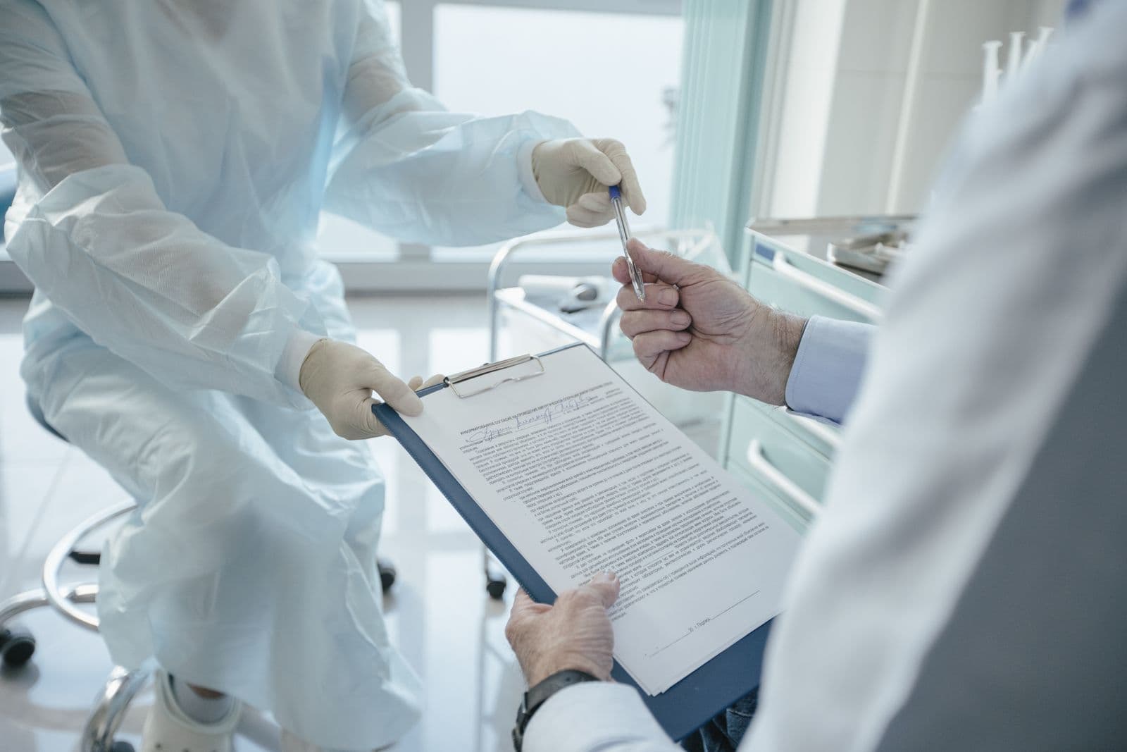 Medical paperwork being handed over for a signature
