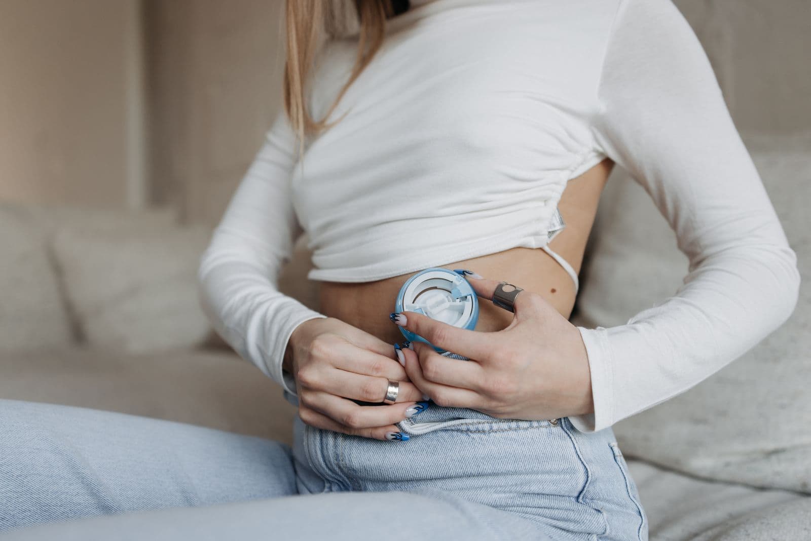 Close-up of a person holding insulin-pump infusion equipment at their waist