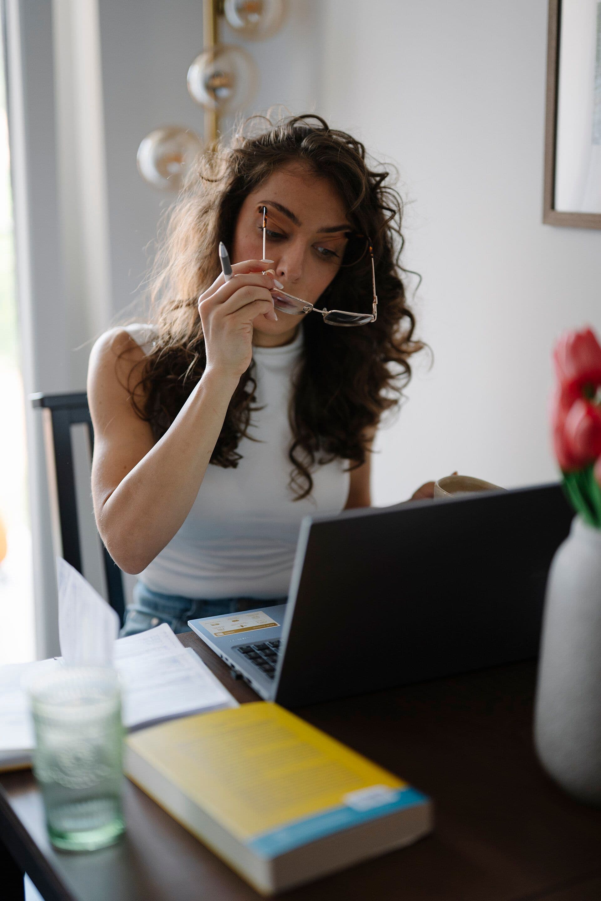 Woman reviewing NBN speed-test results on a laptop at home