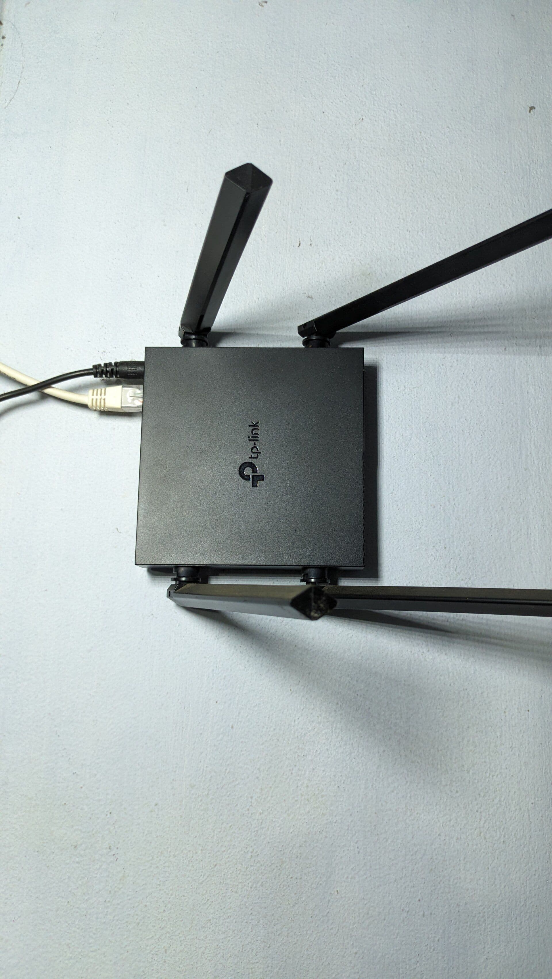 Photograph of a modern dual-band Wi-Fi router on a desk
