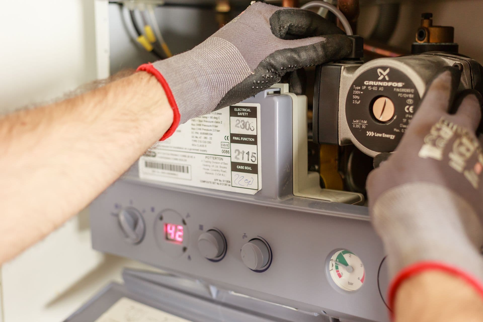 Licensed gasfitter inspecting a household gas heater