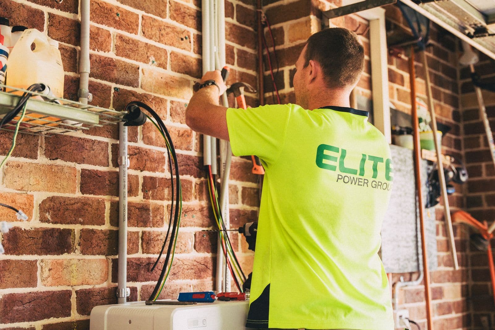 Modern home battery installed beside household electrical equipment