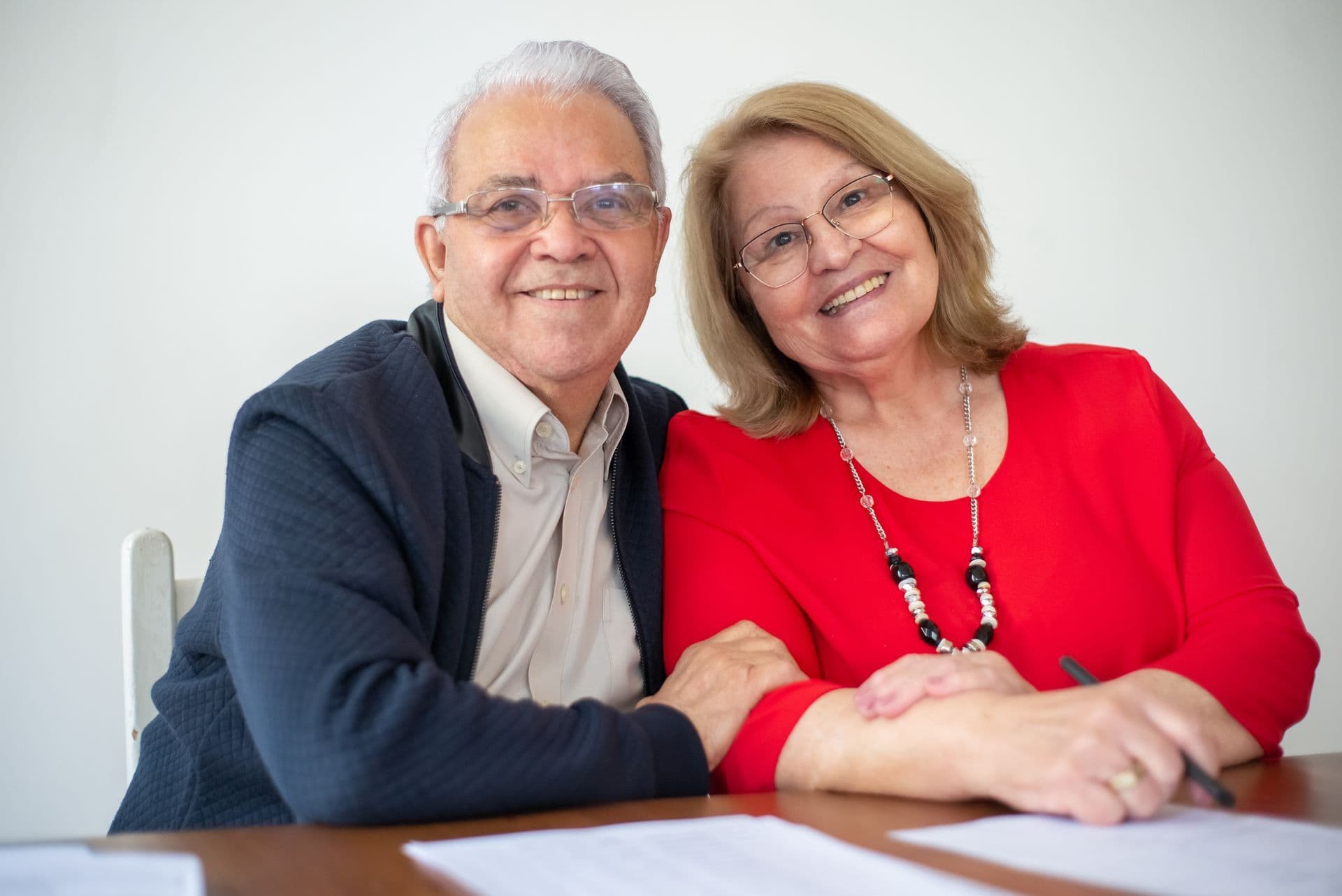 Couple comparing two household electricity plan documents