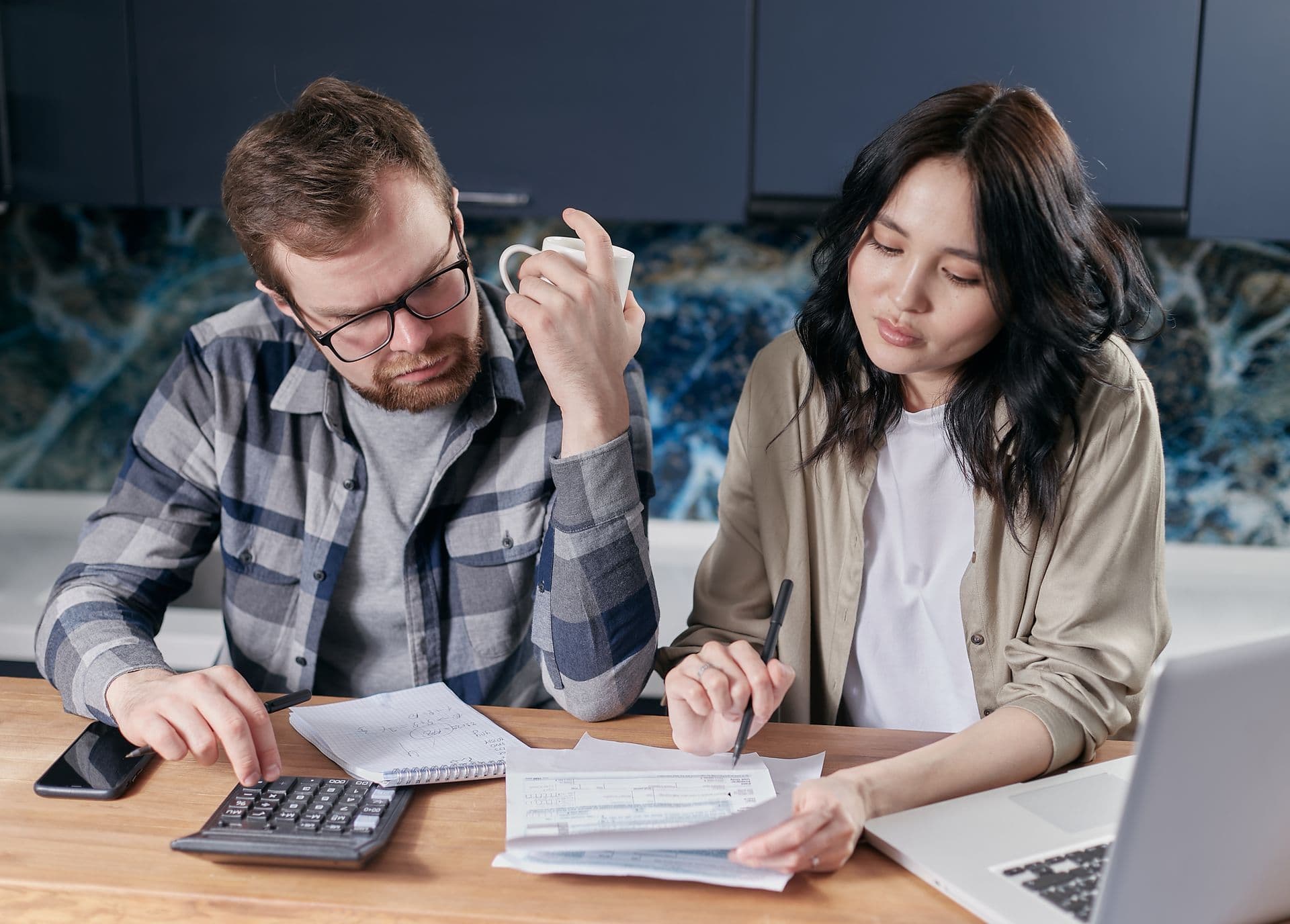 Household reviewing an electricity bill at a kitchen table