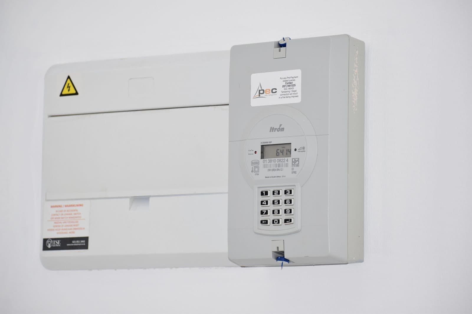 Householder comparing electricity rate options using bills and a calculator