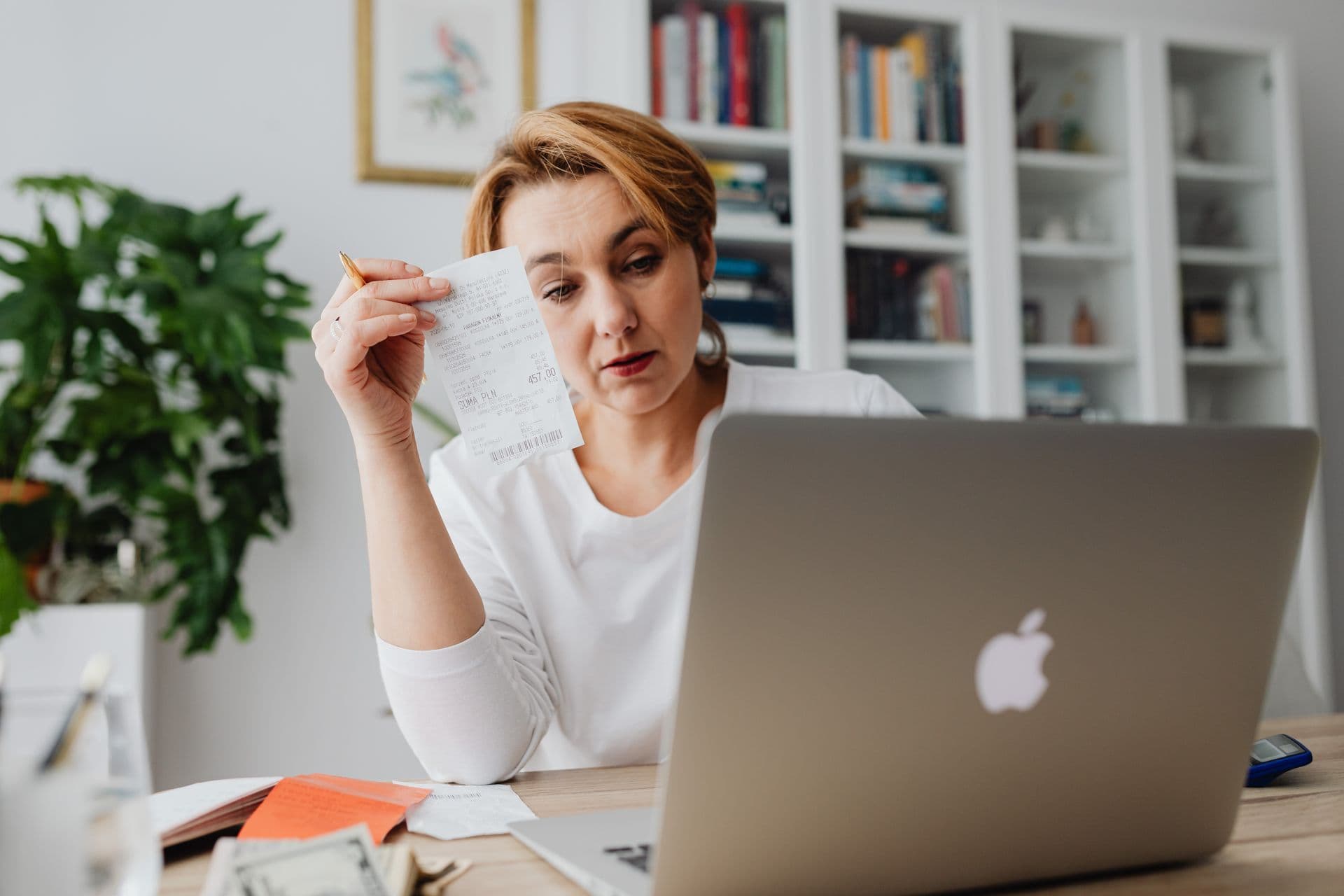 Woman calculating final household charges before cancelling an NBN plan