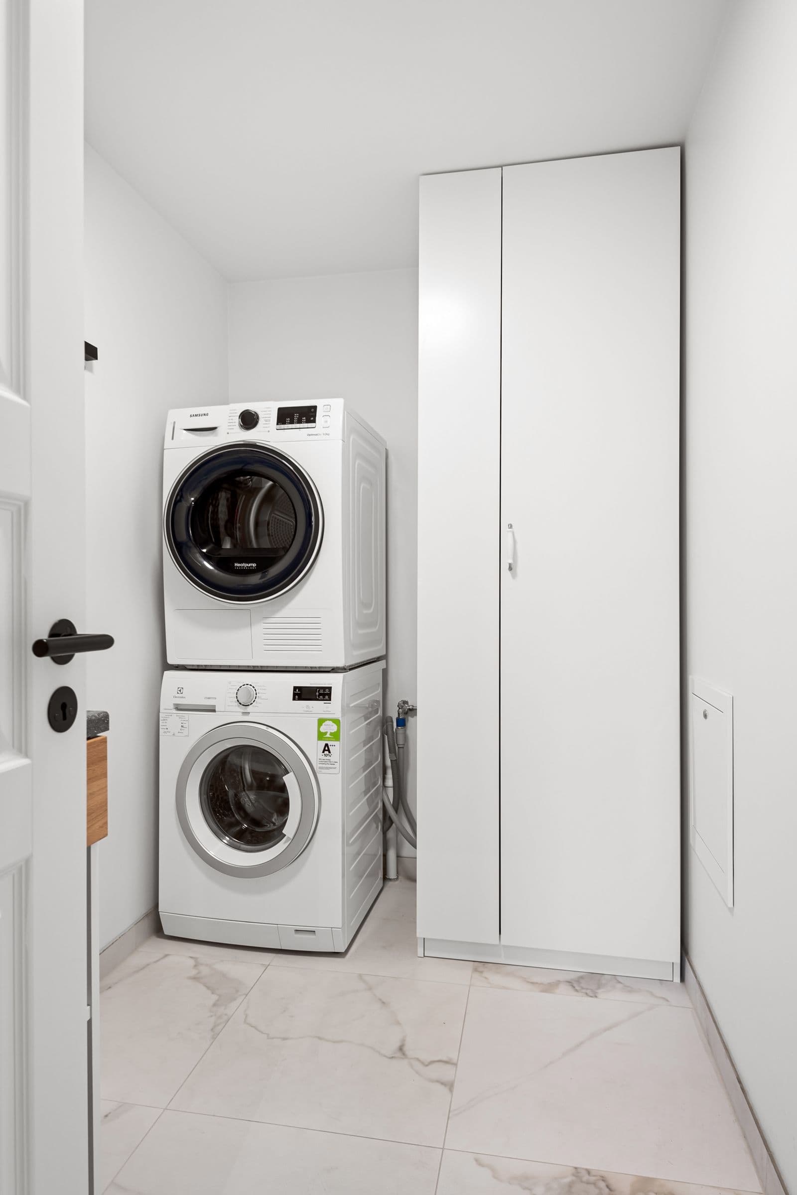 Stacked laundry appliances in a household utility room