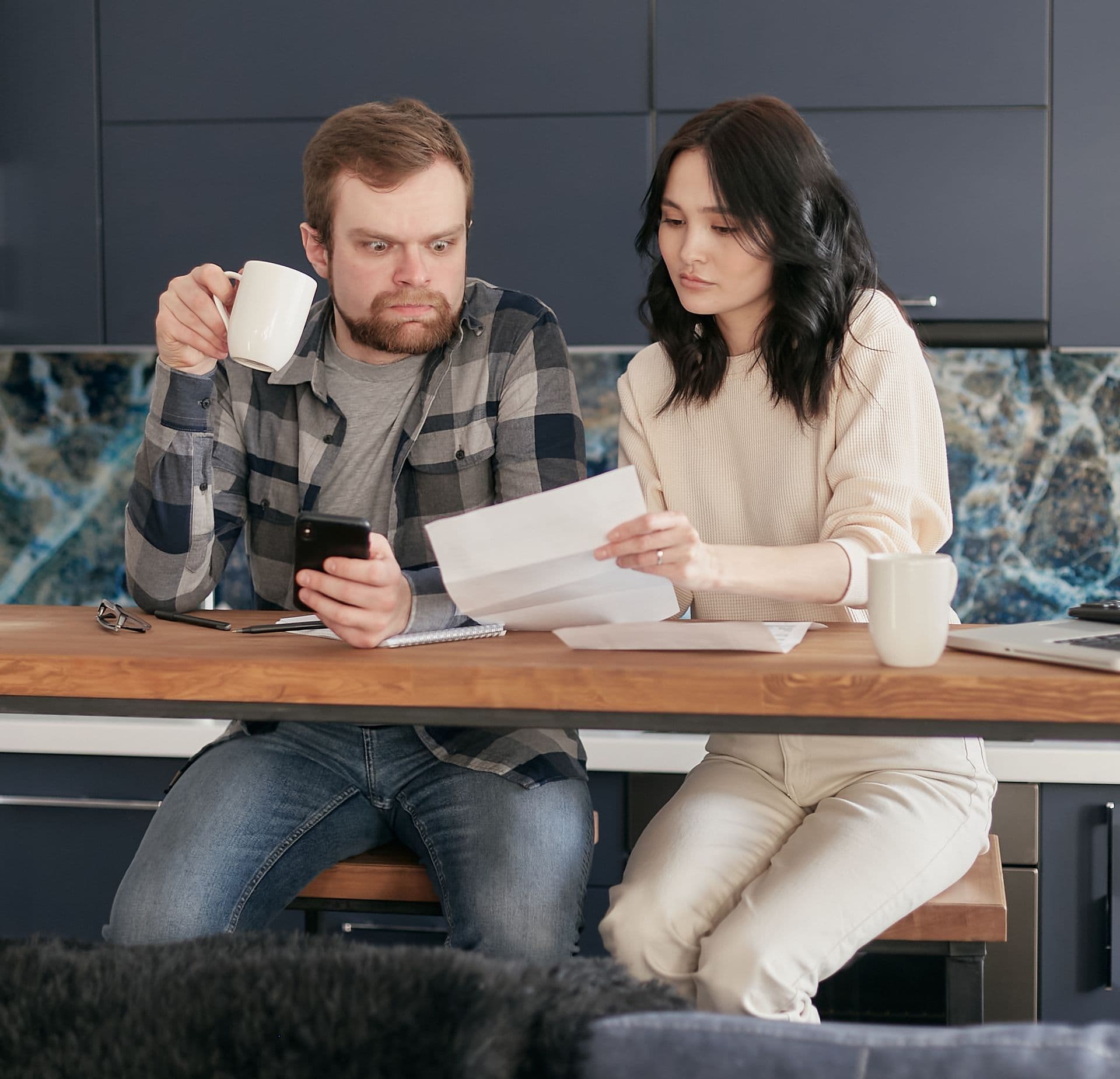 Person carefully reviewing a high household electricity bill