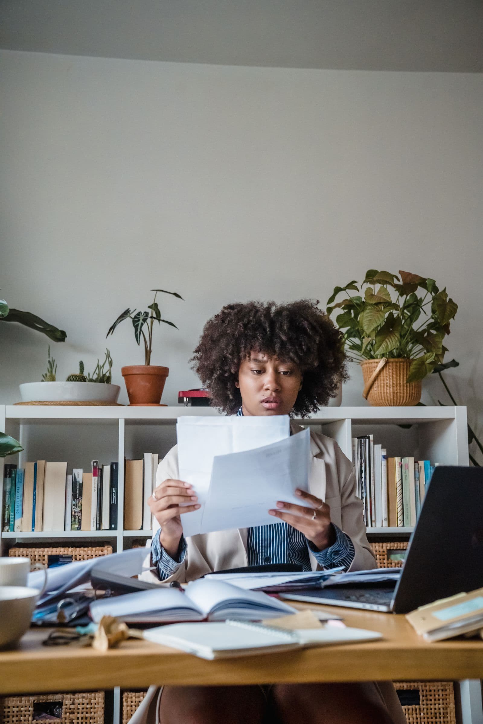 Woman checking paperwork at a home desk