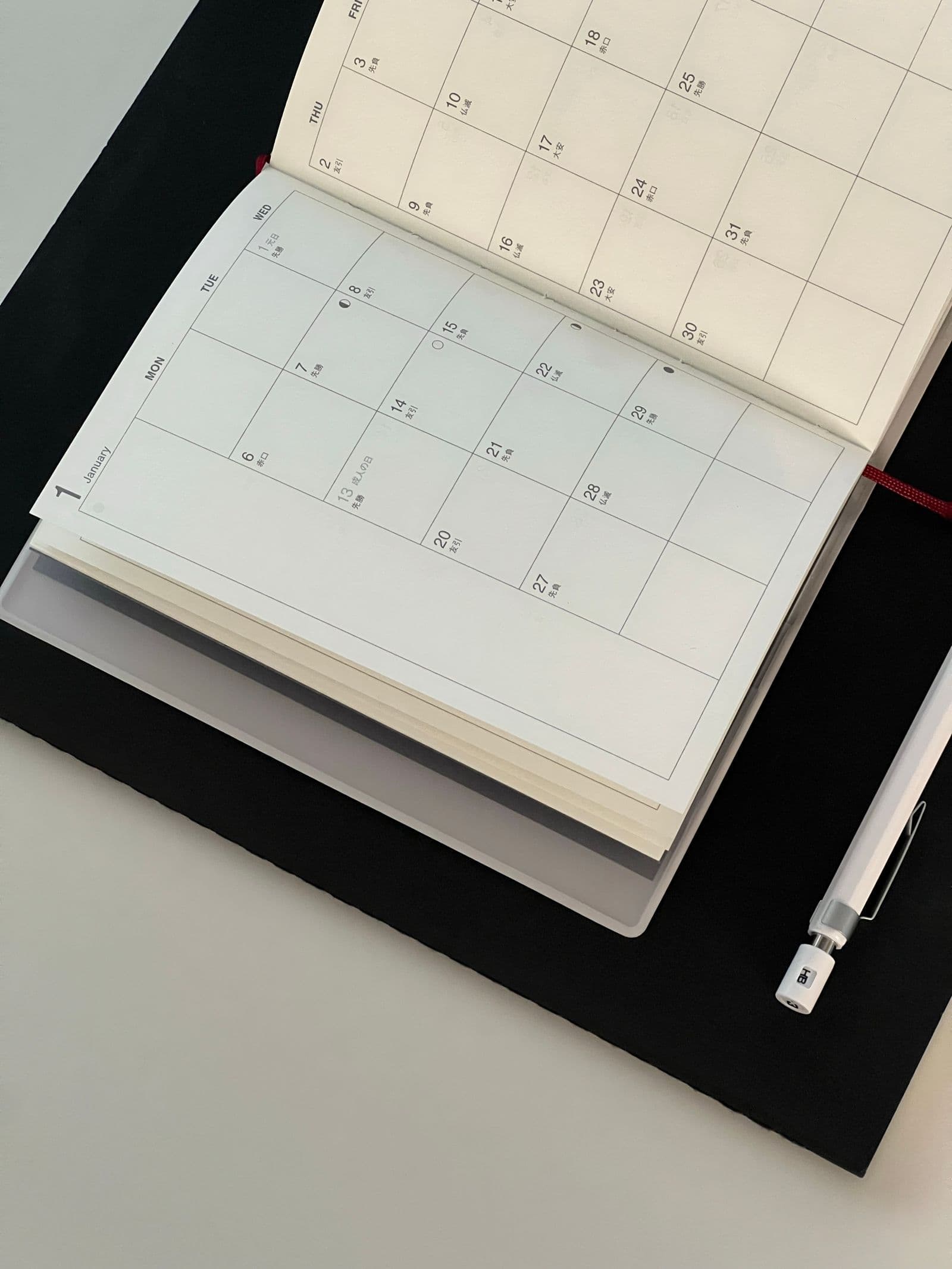 An open calendar and pen for planning upcoming dates