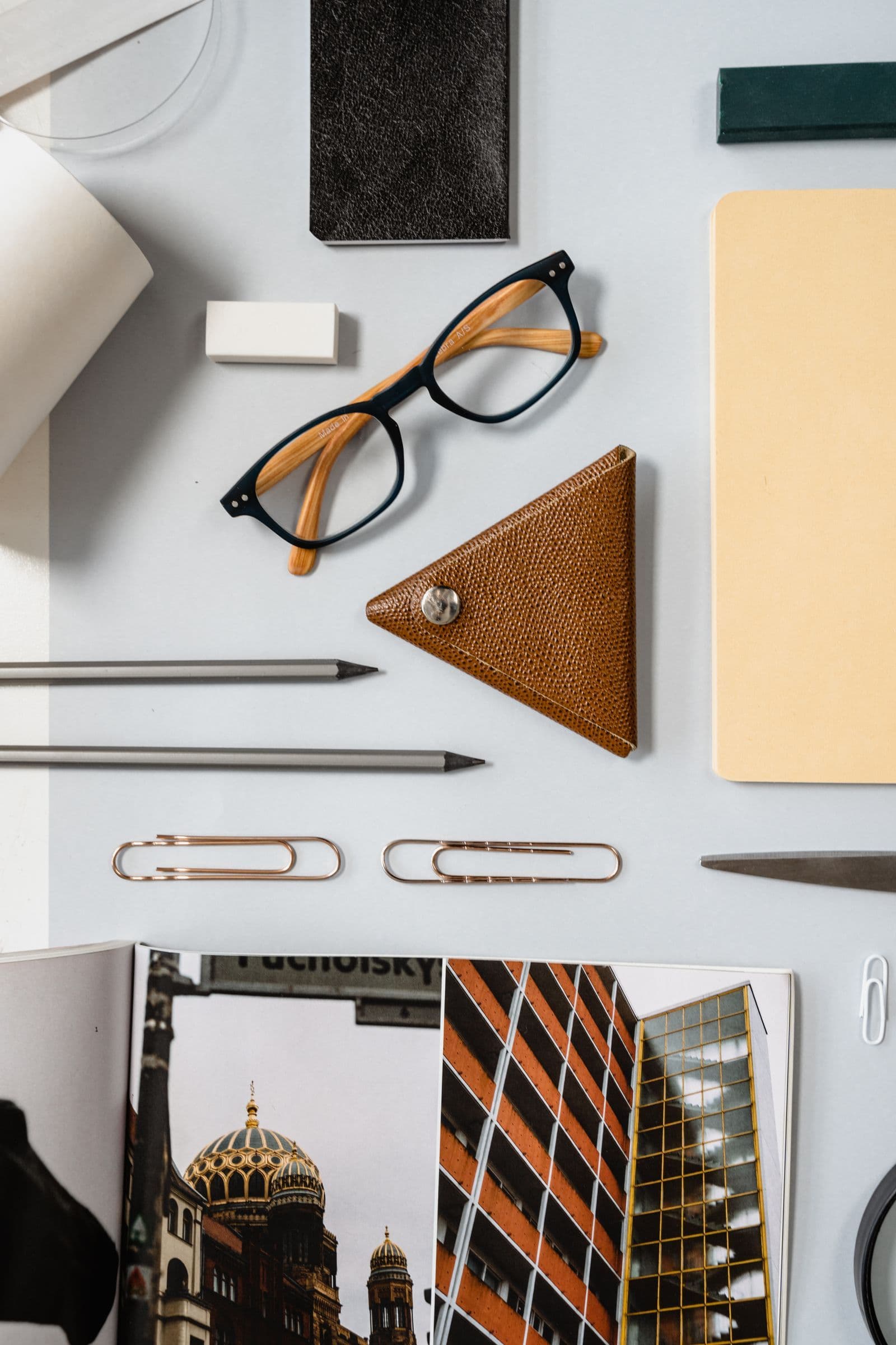 Eyeglasses and stationery on a white desk