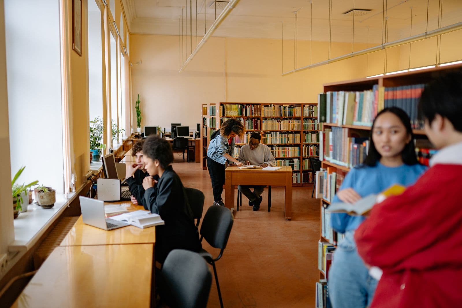Students reading and studying at a library table