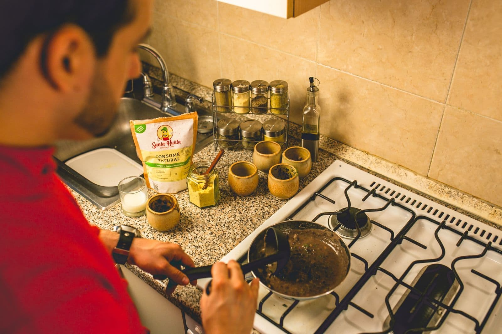 Person preparing food on a gas cooktop