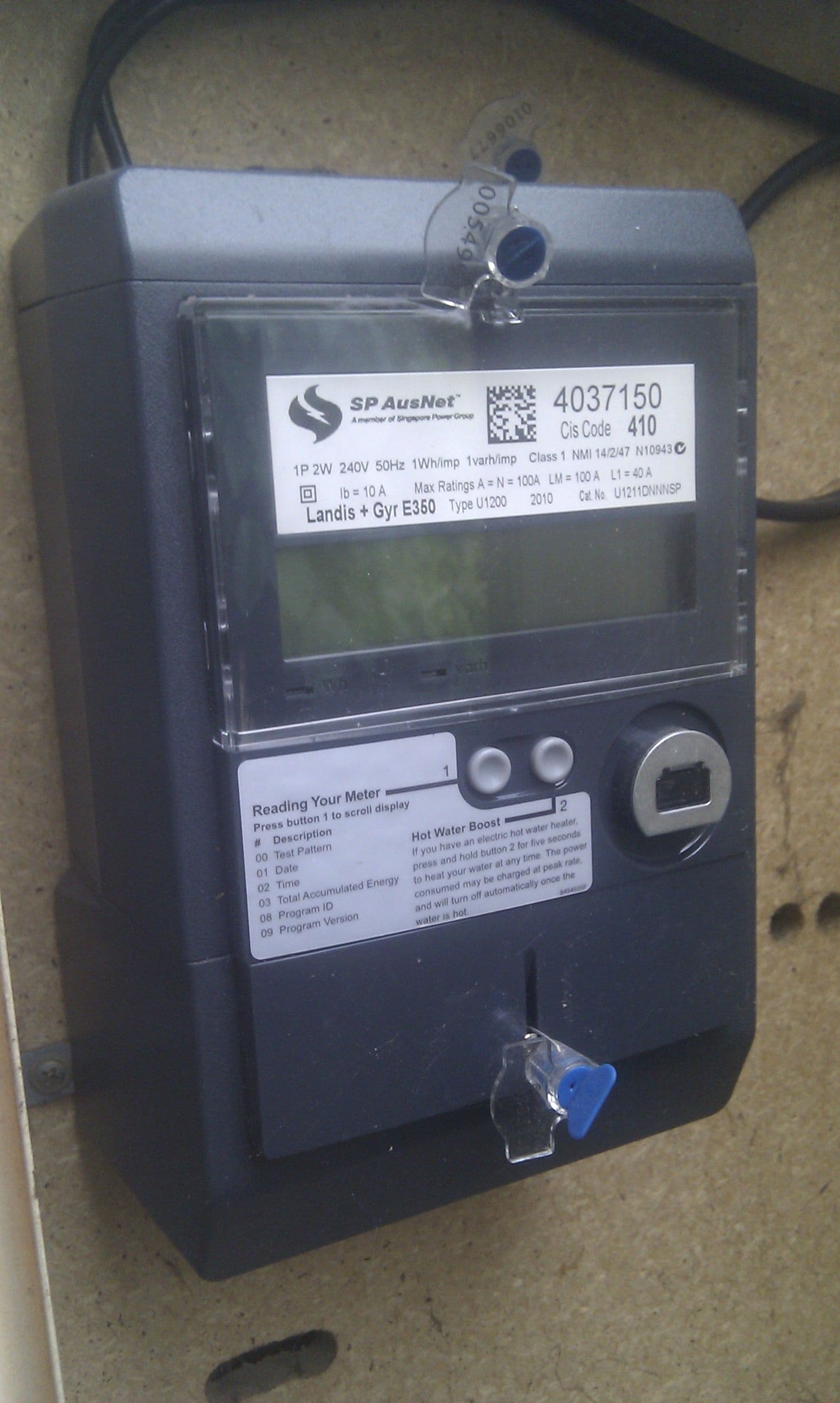 Smart meter on a wall, representing time-of-use electricity pricing.