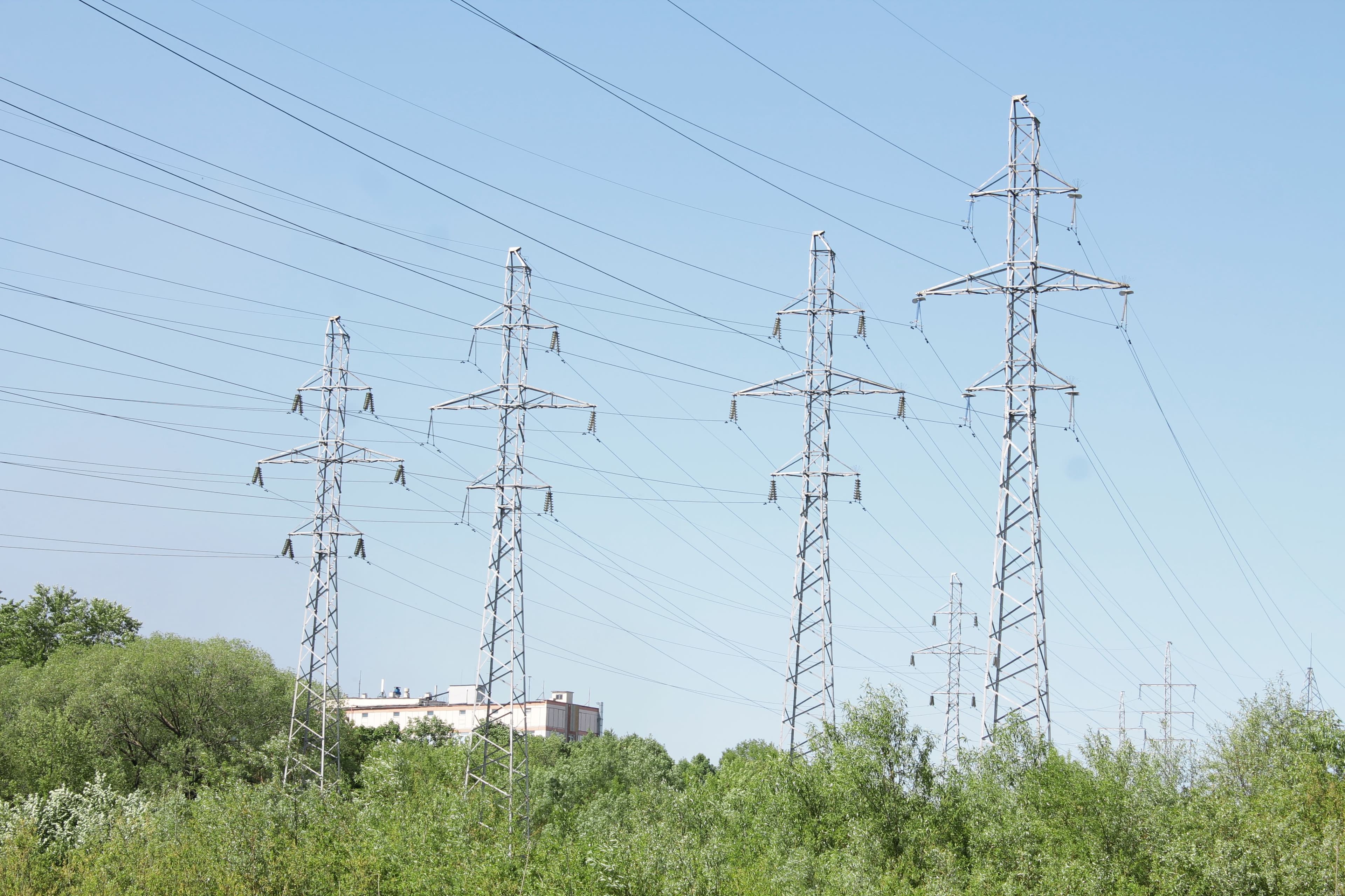Electric transmission tower and lines illustrating electricity network infrastructure.