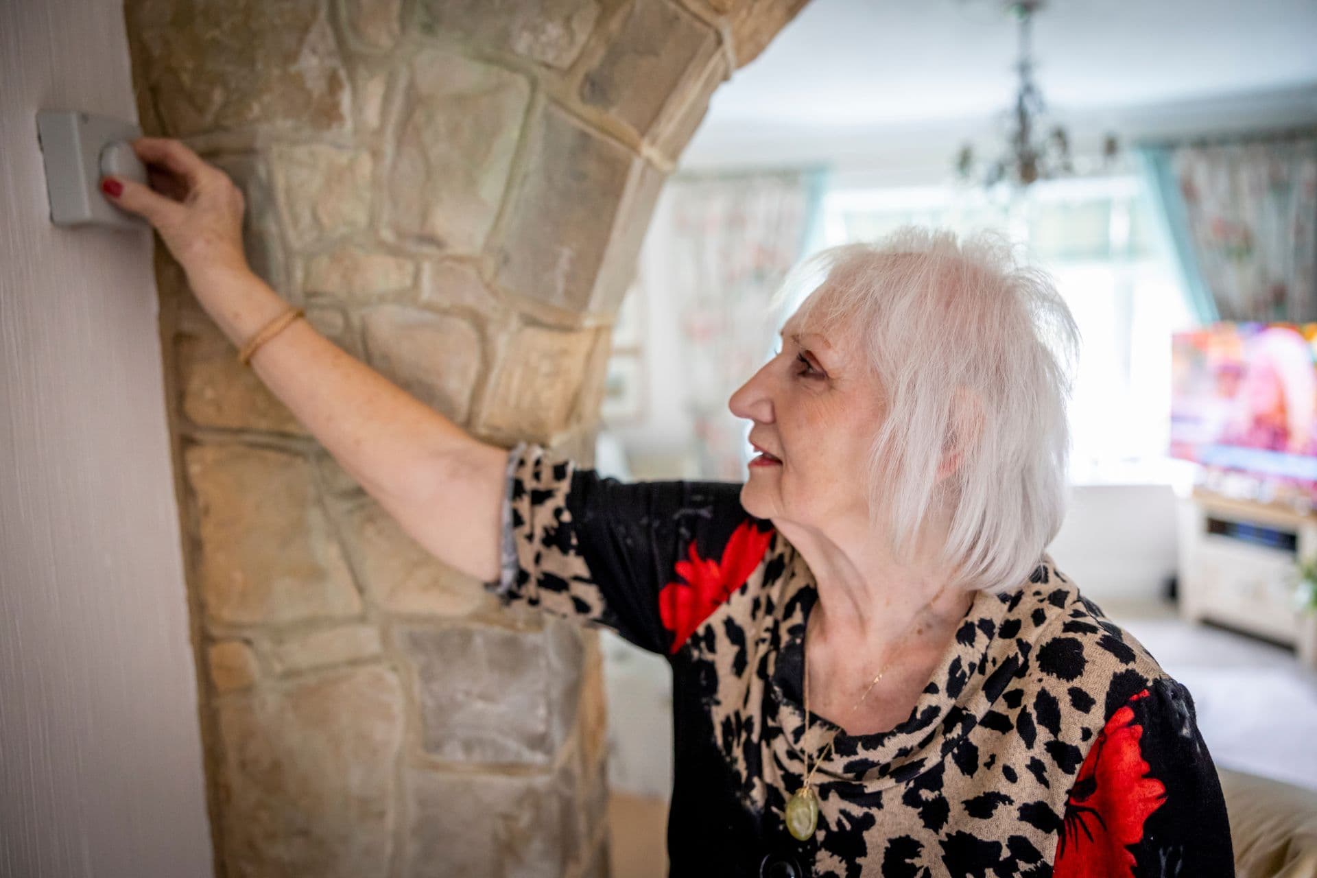 Householder comparing a winter gas bill near a heater