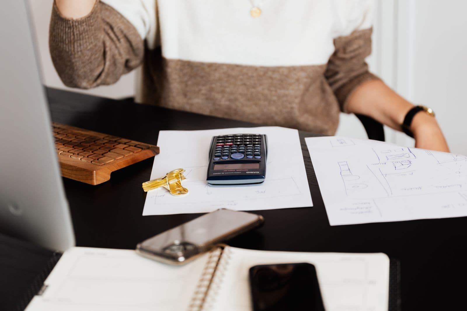 Calculator and documents on a desk for budgeting