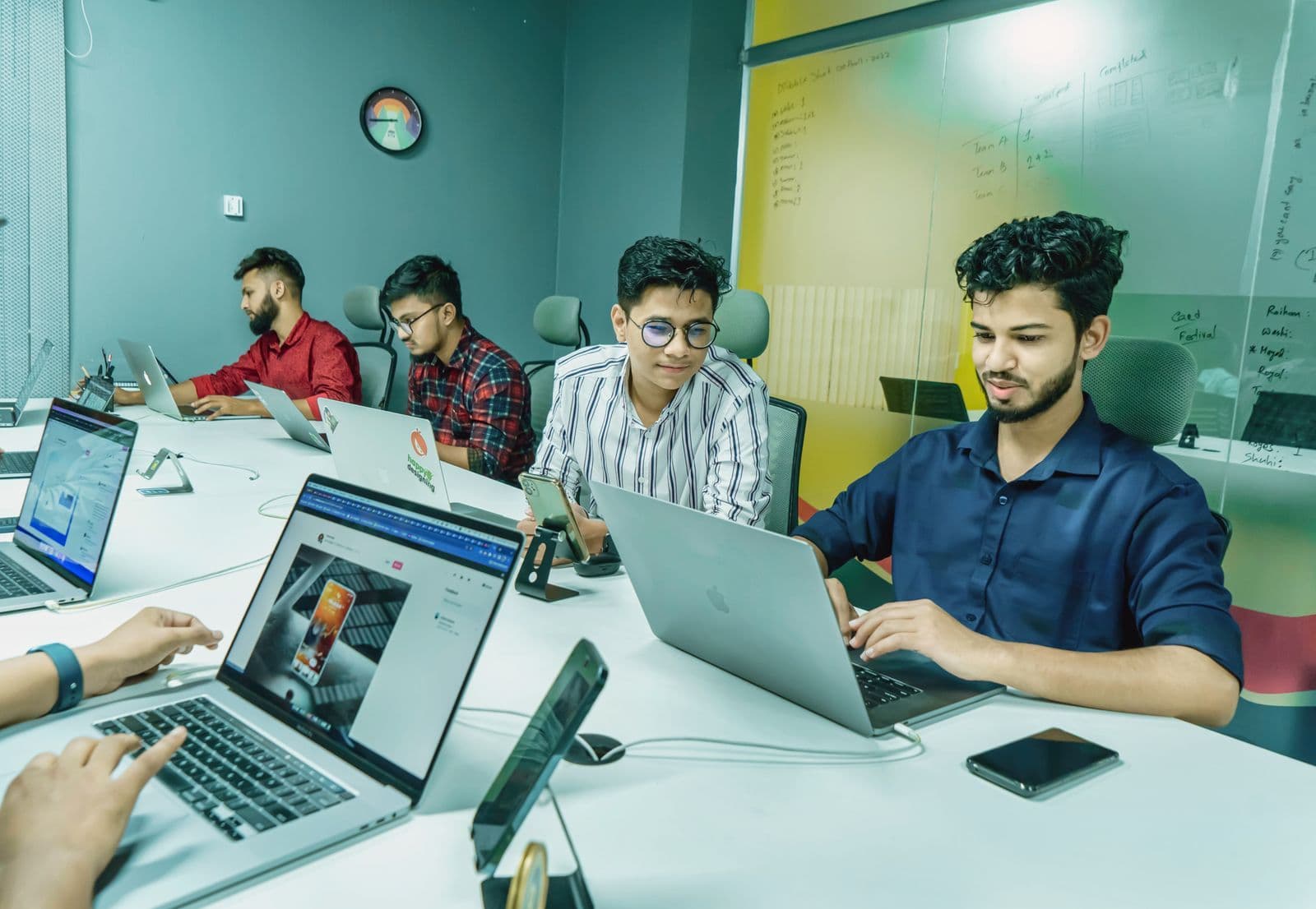 Small office team working together on laptops