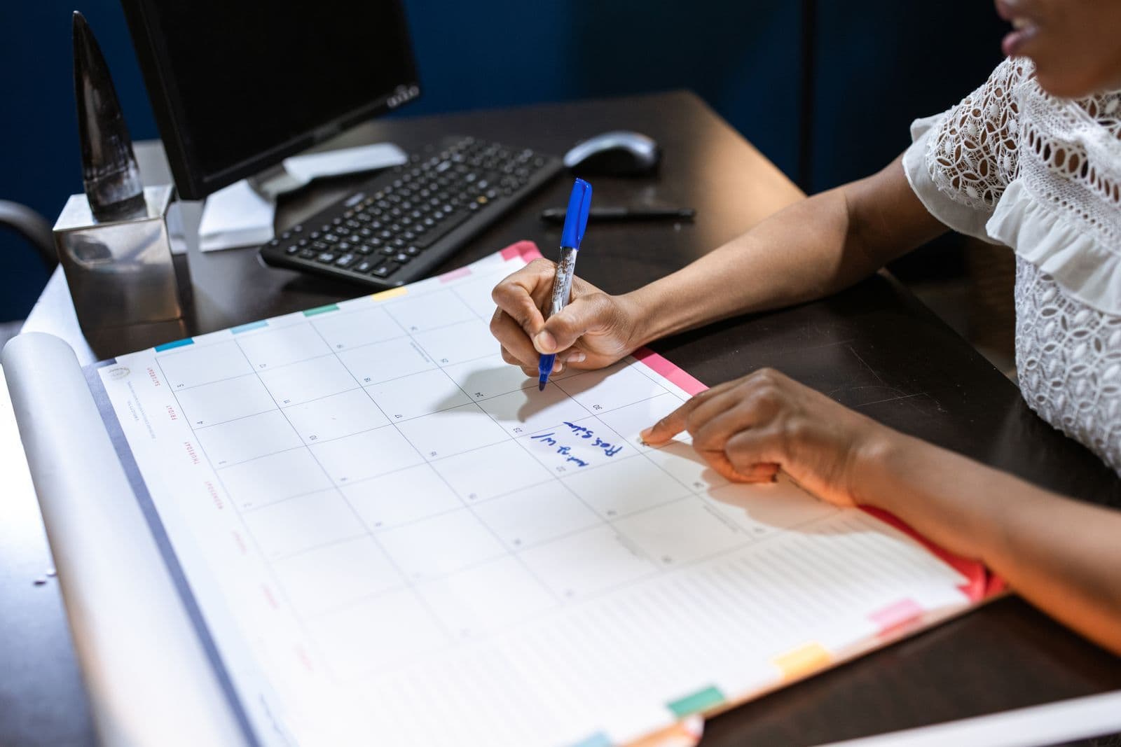 A person planning dates on a calendar