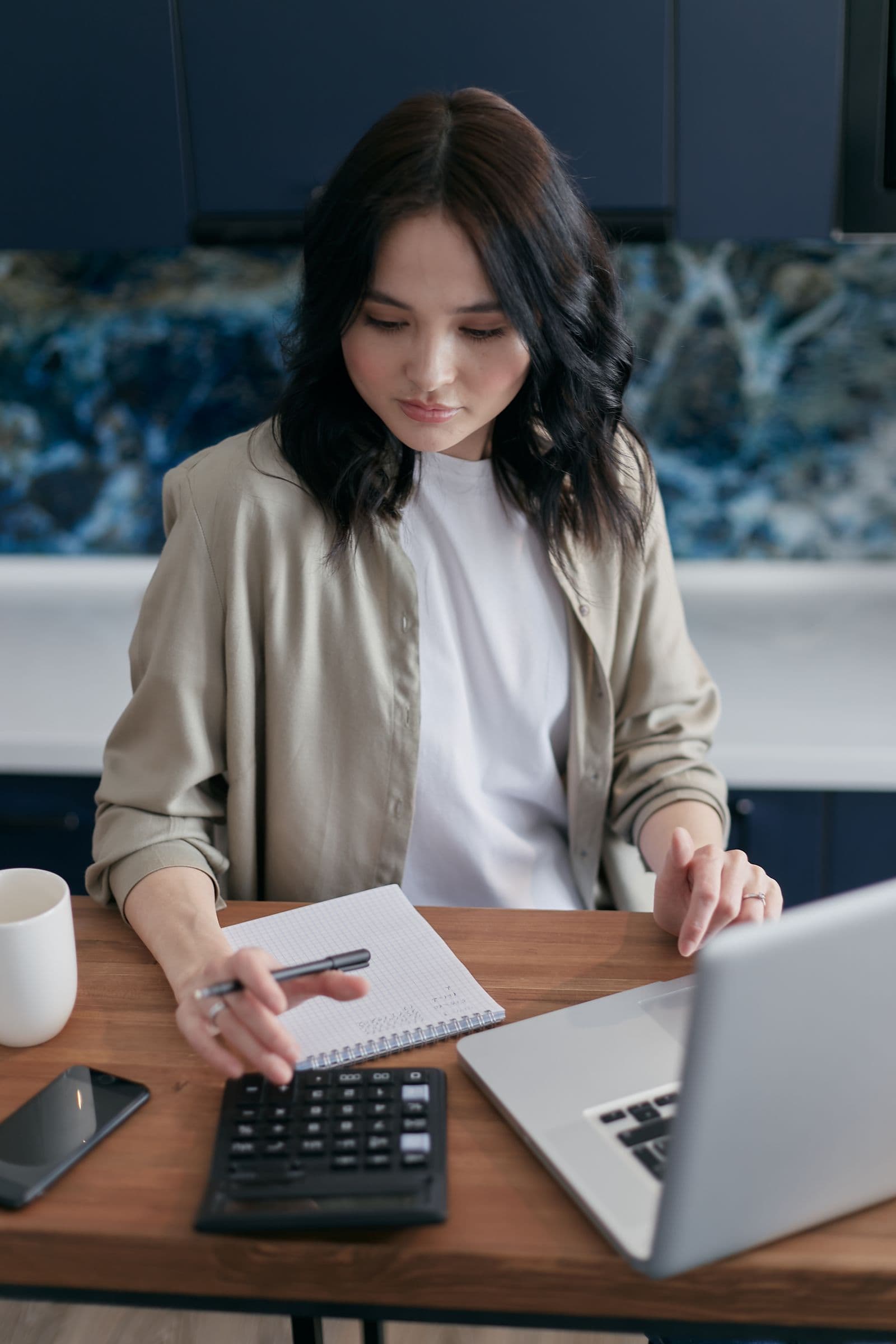 Person calculating the annual cost of competing electricity offers