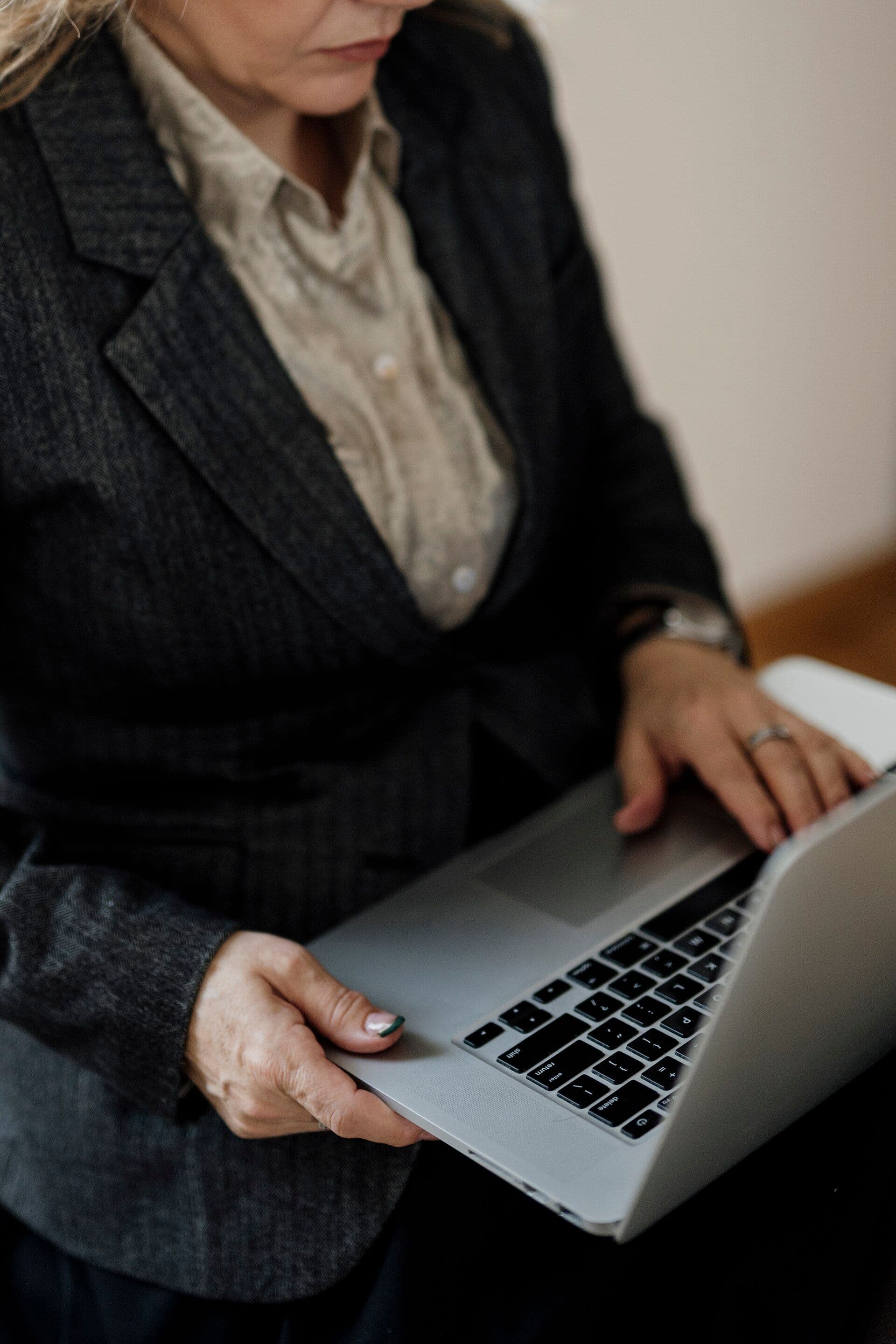 Woman using a laptop in a bright office while checking home internet speed