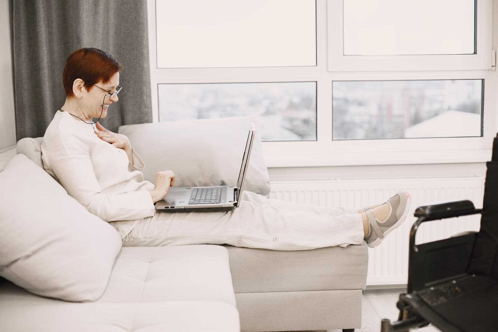 A person using a laptop for a video call at home