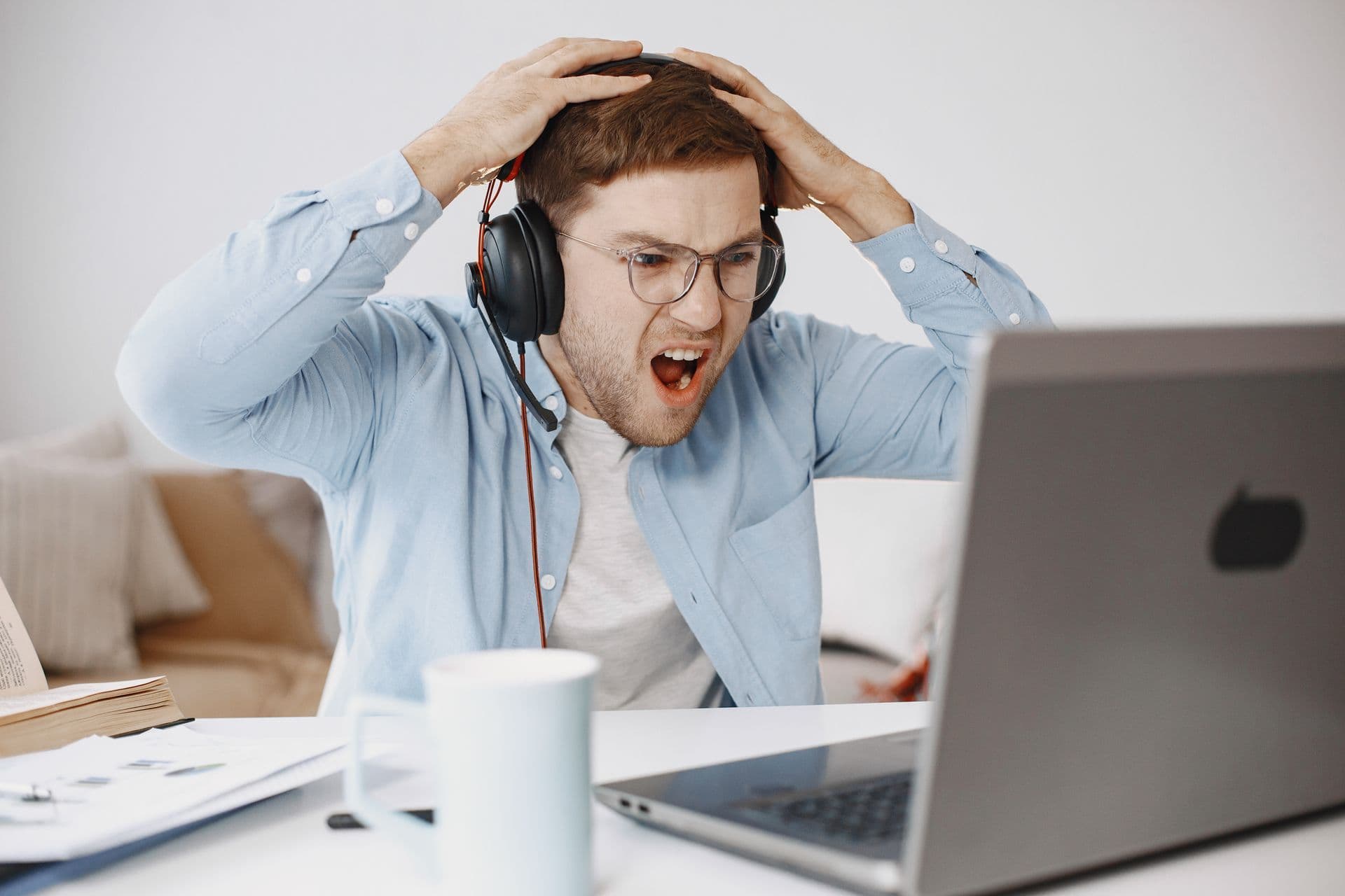 Frustrated remote worker checking a laptop during an internet outage