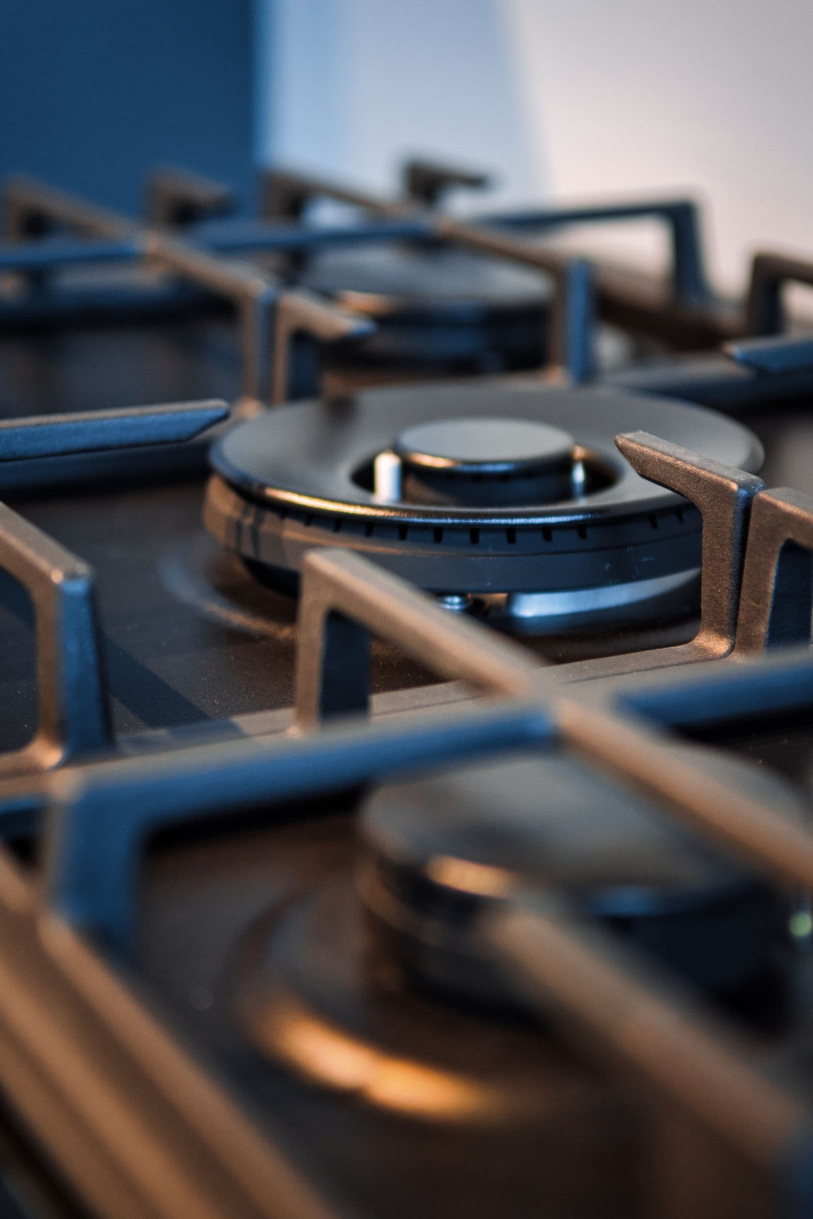 Close-up of a gas cooktop burner and metal grate