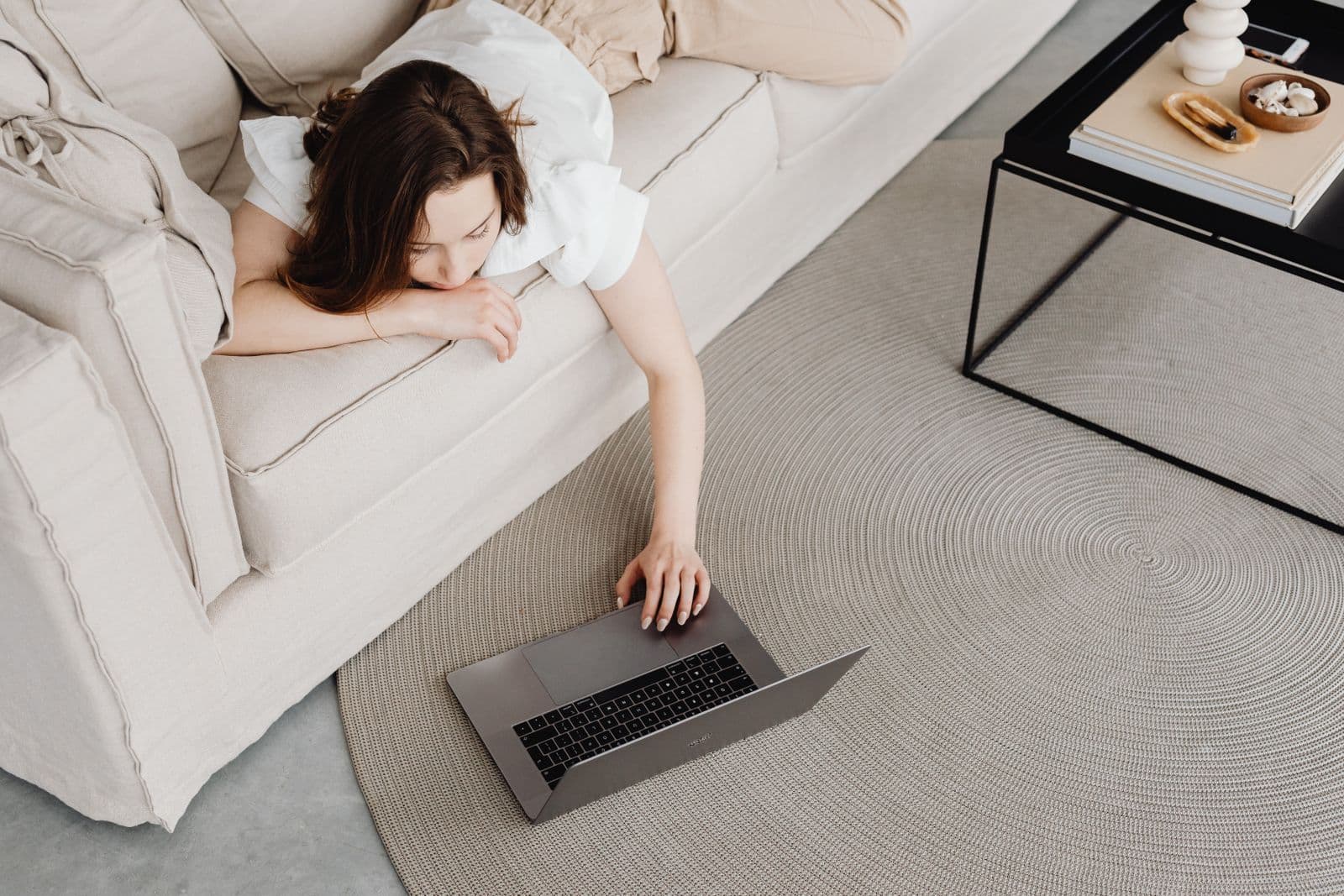 A person using a laptop while relaxing at home