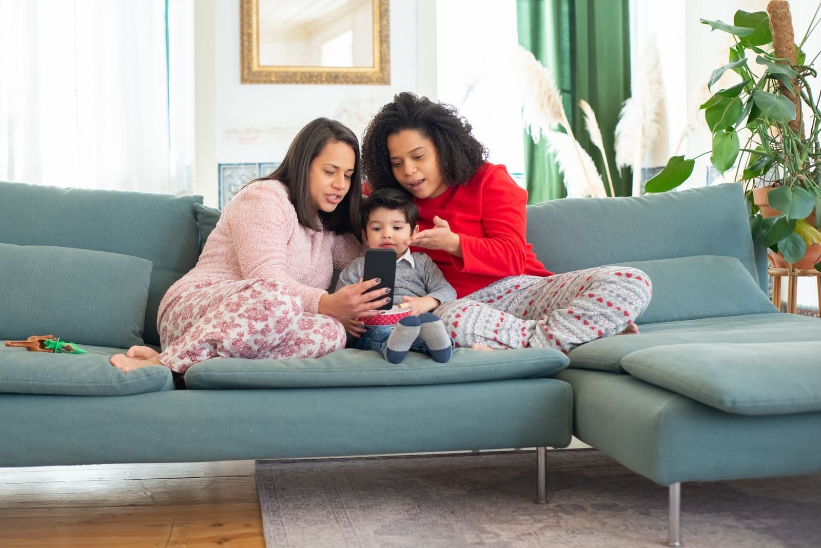 Family members comparing mobile phones and plans at home